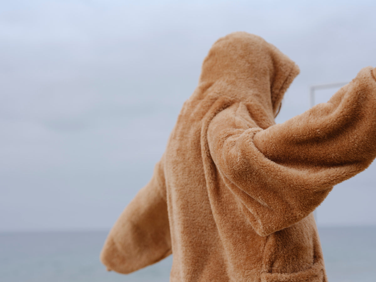 Camel Brown Crop Papàsweater modeled on the beach