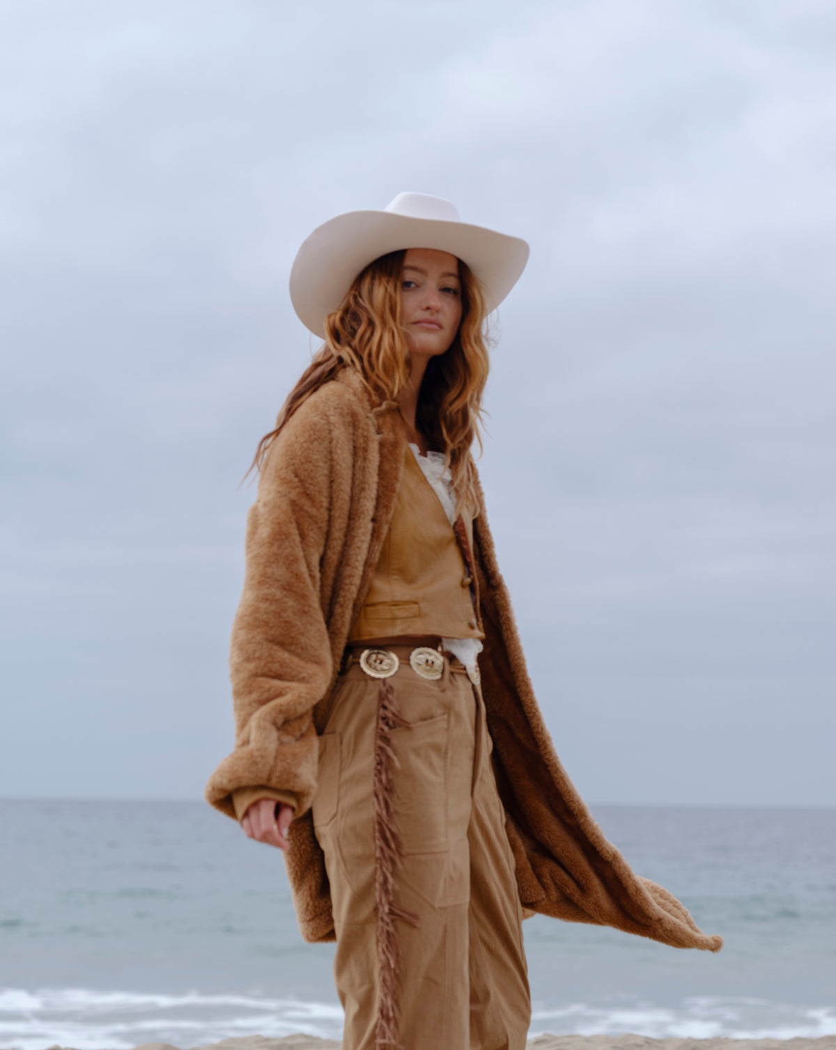 Camel Brown Long Papàsweater modeled on the beach