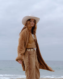 Camel Brown Long Papàsweater modeled on the beach