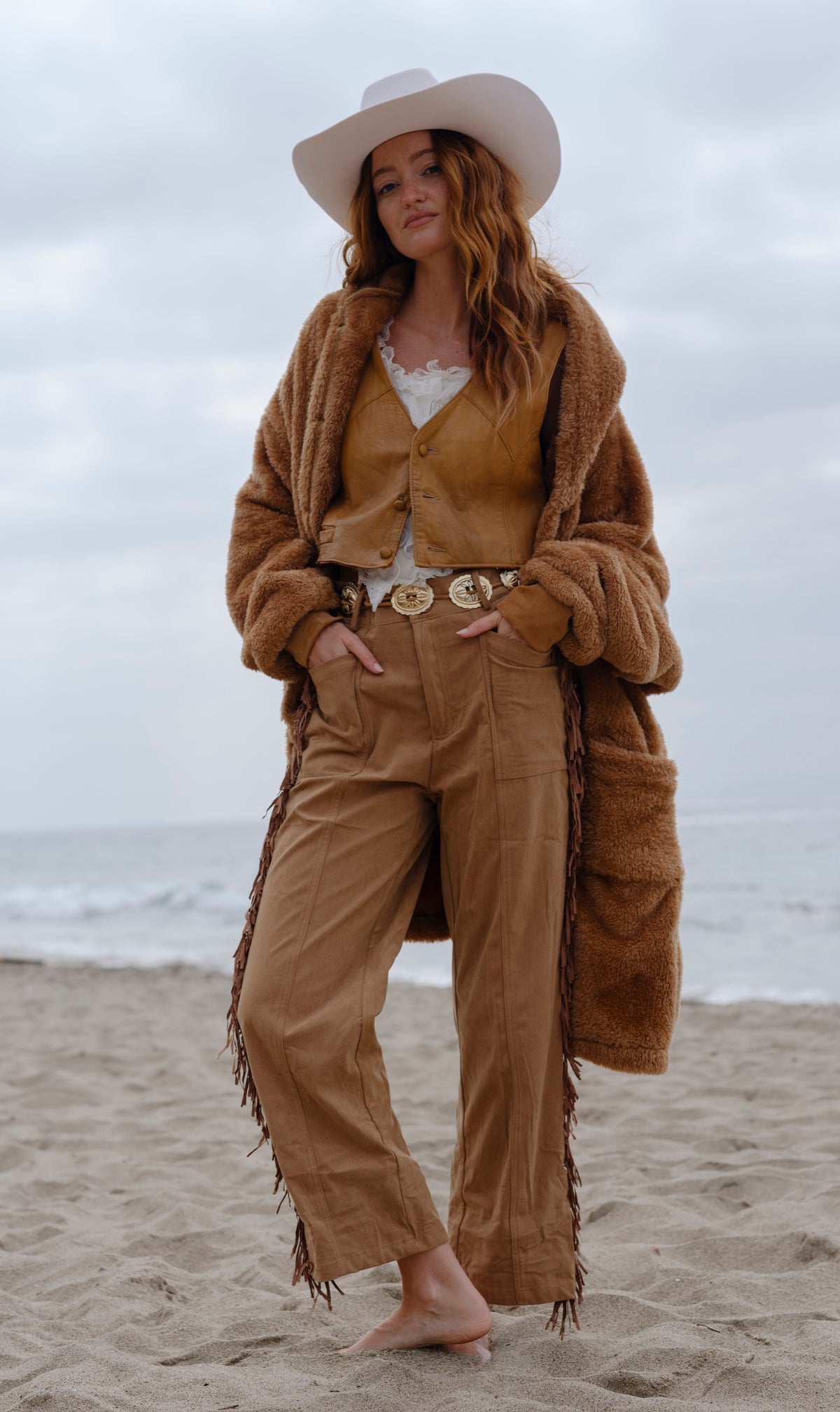 Camel Brown Long Papàsweater modeled on the beach